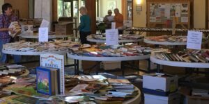 A group of people looking at books in a room.