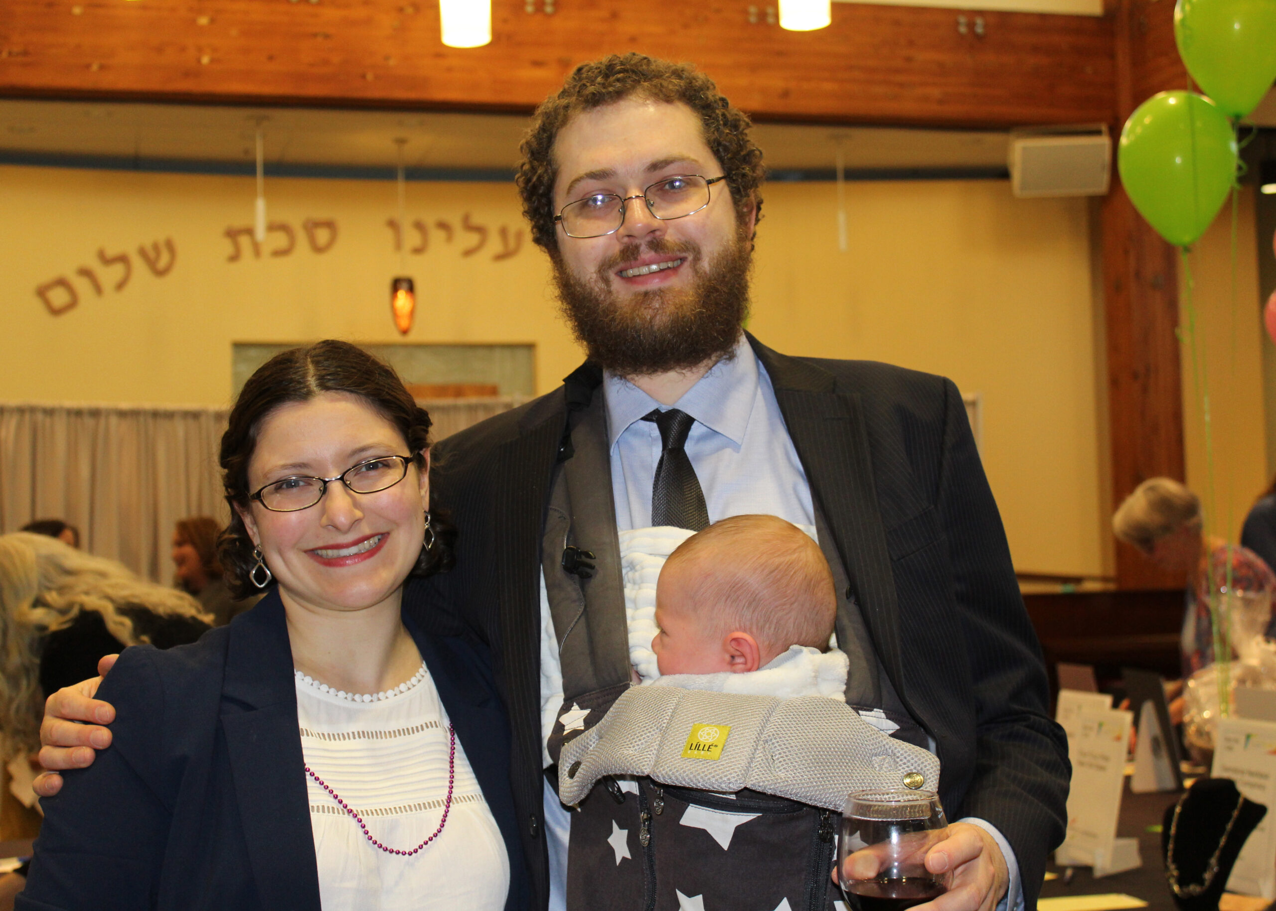 A man and woman holding a baby in his arms.