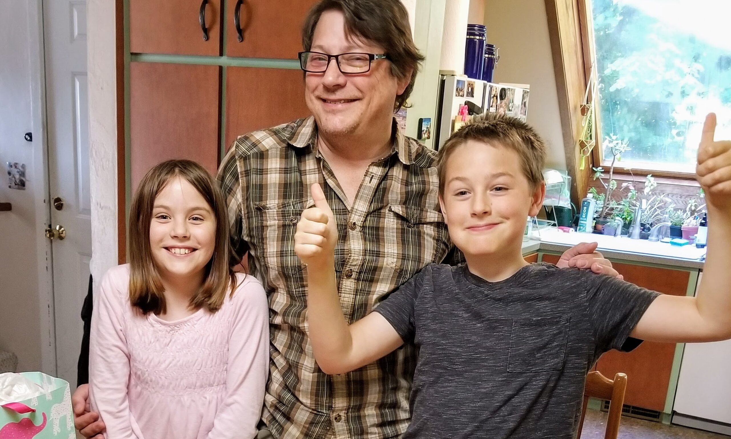 A man and two children posing for the camera.