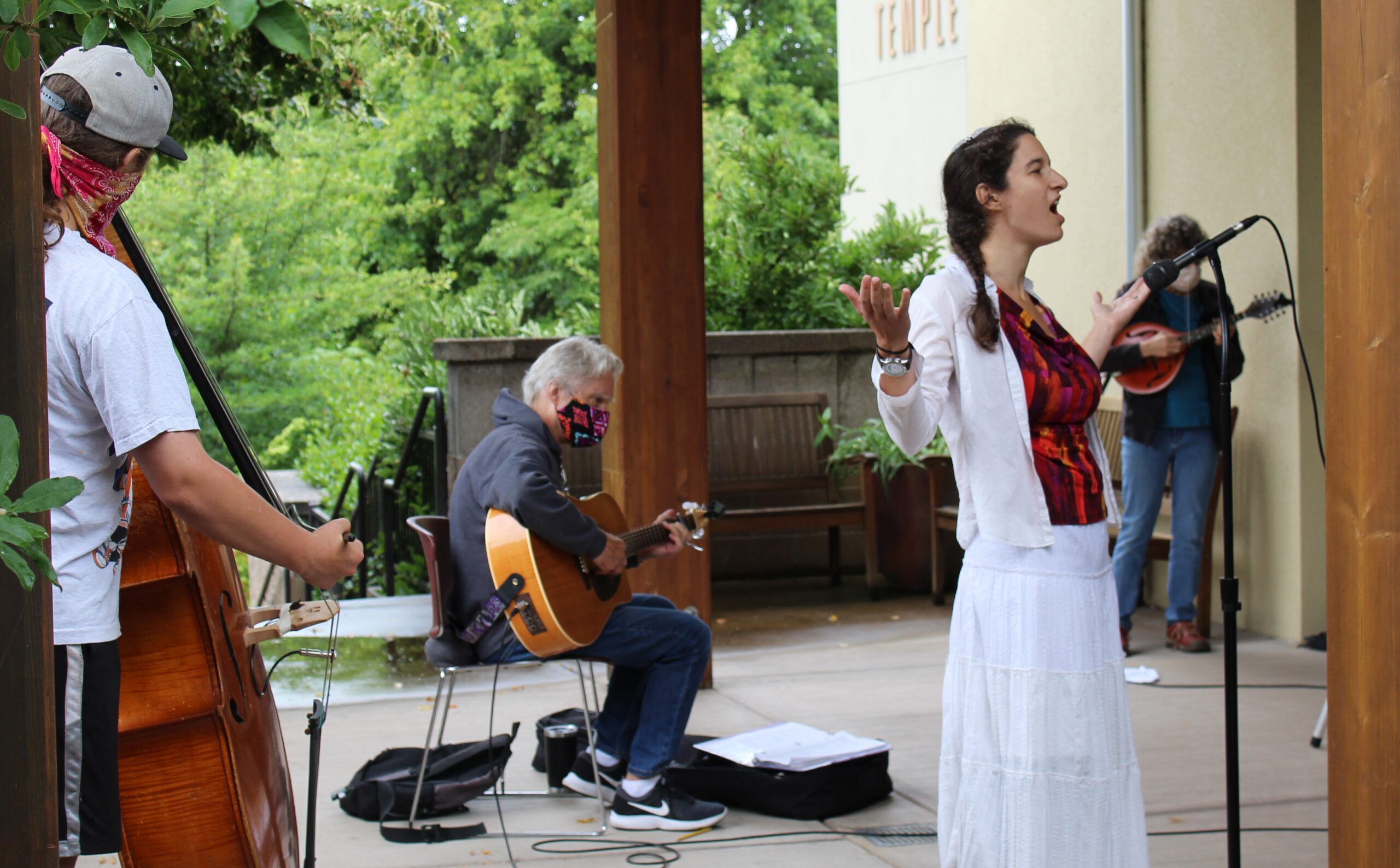 A group of people singing and playing instruments.