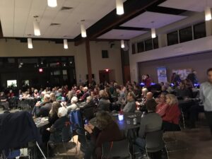 A large group of people sitting at tables.