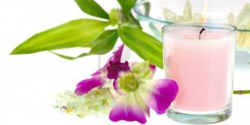 A candle and some flowers on a table