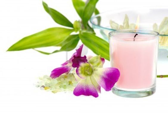 A candle and some flowers on a table