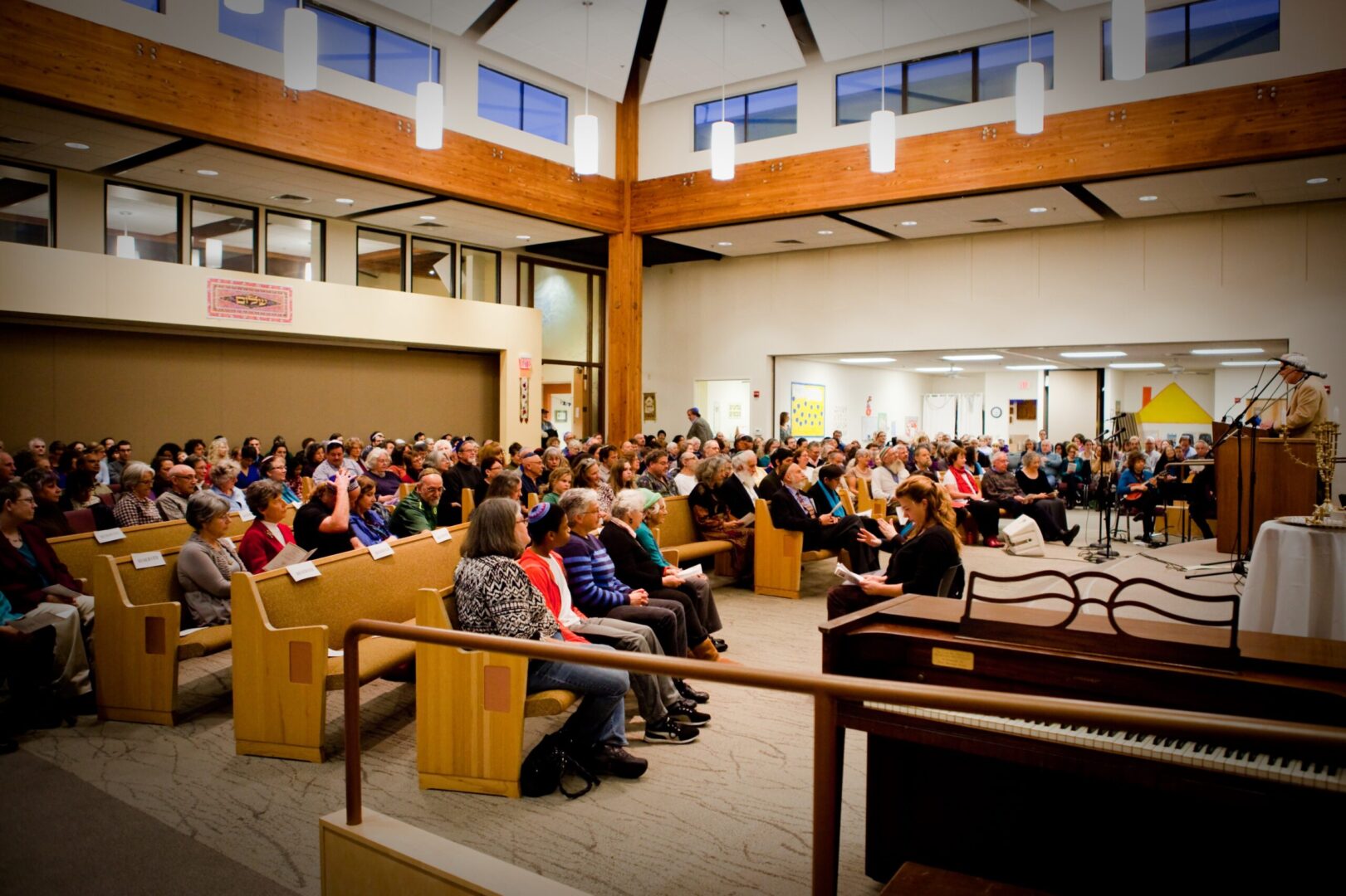 A large group of people sitting in church.