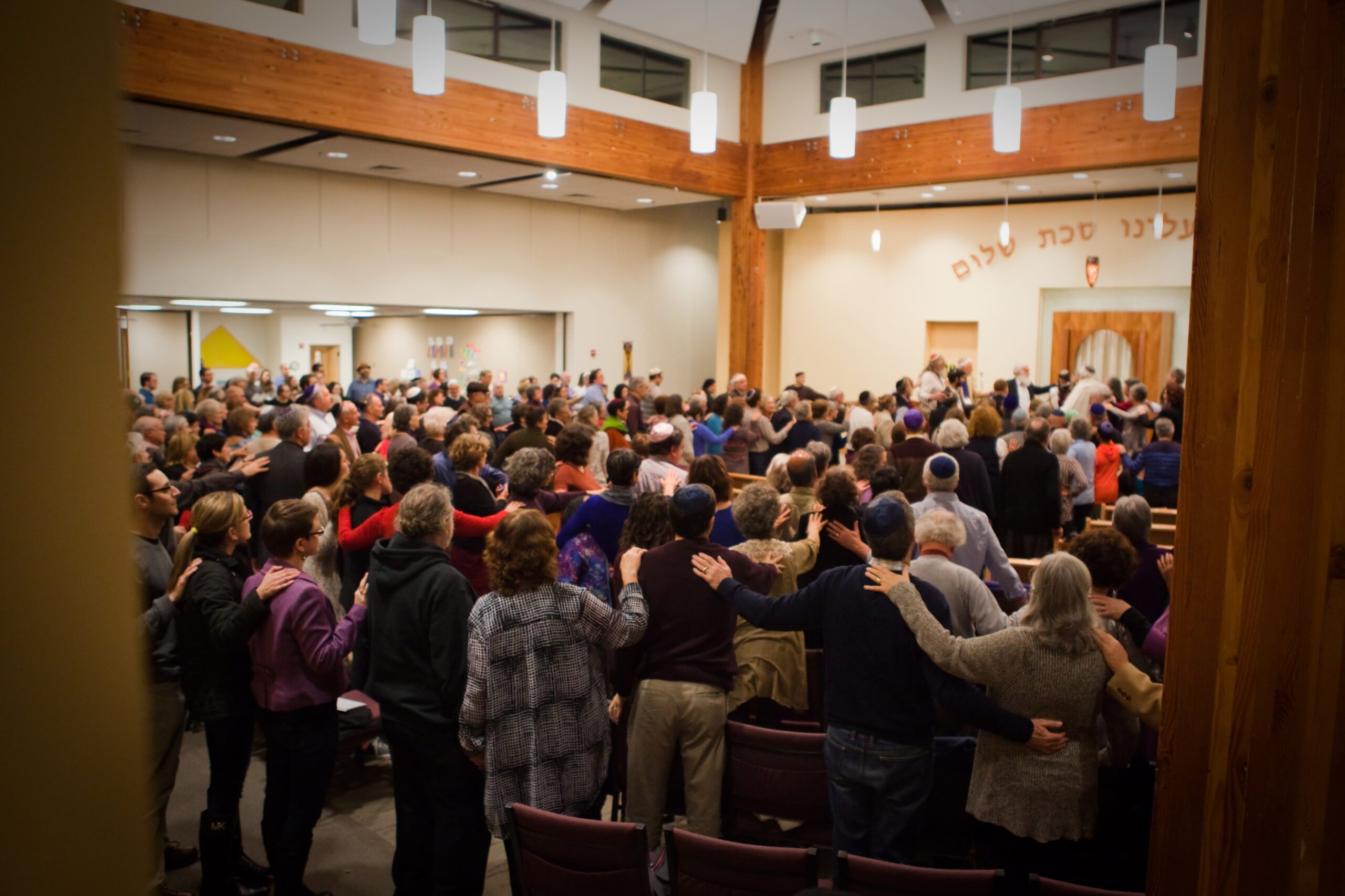 A large group of people in the middle of an assembly hall.