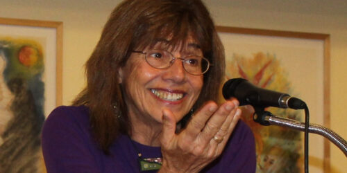 A woman with glasses and a purple shirt
