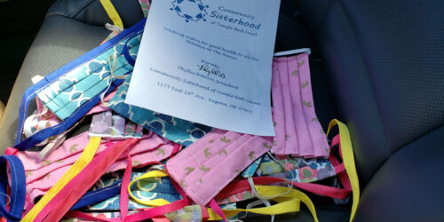 A pile of masks and ribbons with a certificate.