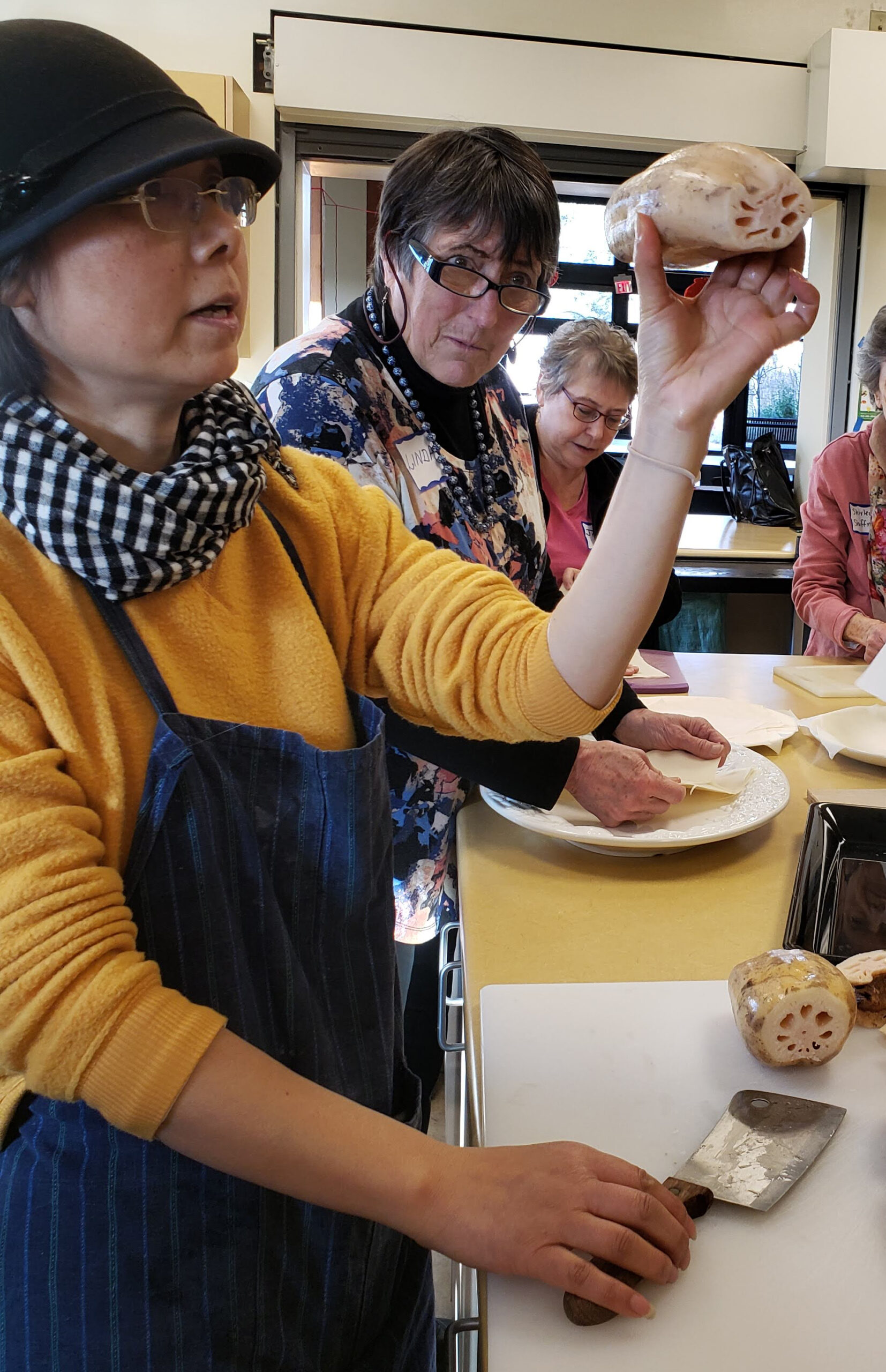 A group of people standing around a table.