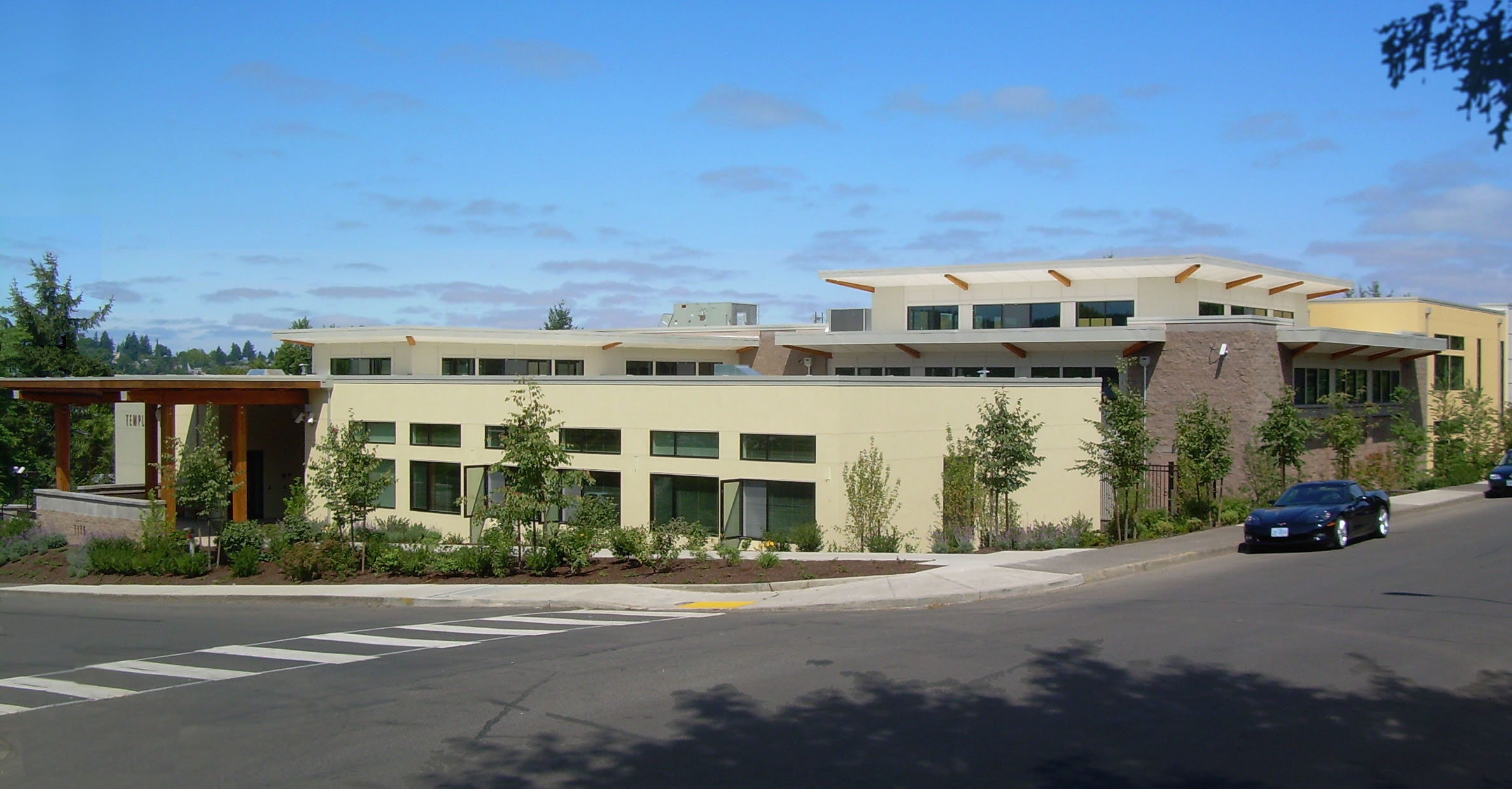 A building with many windows and trees in front of it