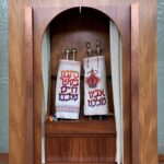 A wooden cabinet with two bags of food on top.