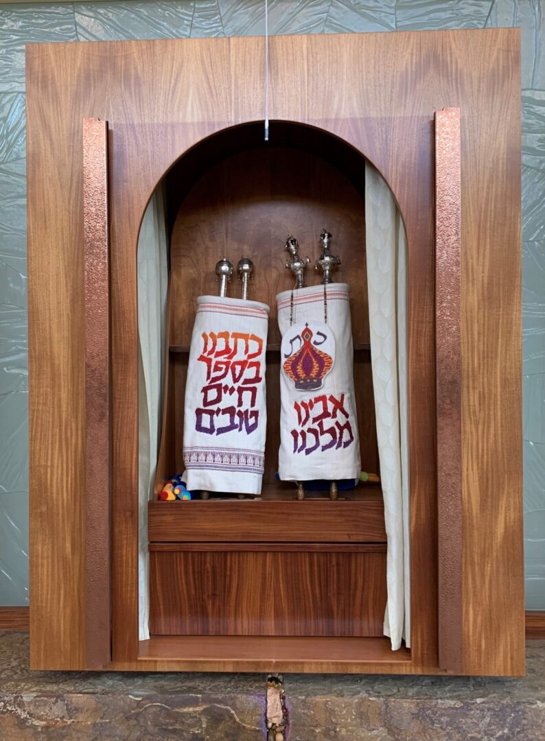 A wooden cabinet with two bags of food on top.