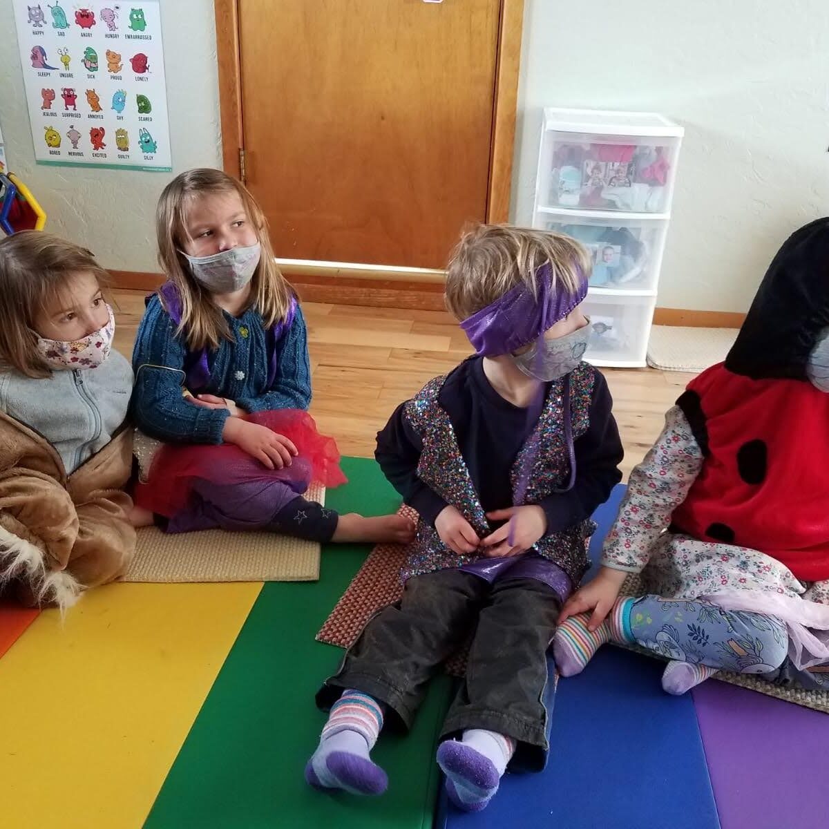 A group of children sitting on the floor.