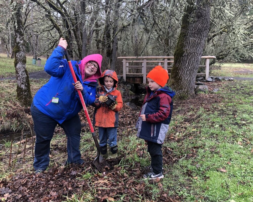 A woman and two children in the woods