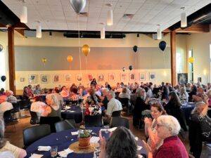 A large group of people sitting at tables.