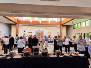 A group of people standing around a table.